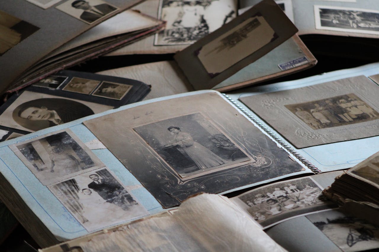 contact-img Explore vintage family photo albums filled with black and white photographs, capturing timeless memories.